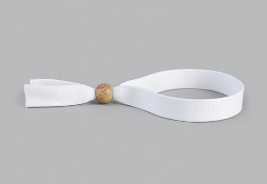 White cloth wristband with wooden bead on grey background, ai generated. Adjustable fabric bracelet mockup for festivals, concerts, events, hotels, resorts, clubs, promotional and custom printing.