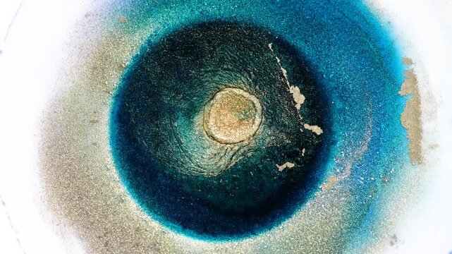 Mixing alcohol ink in macro view with vibrant colors and patterns