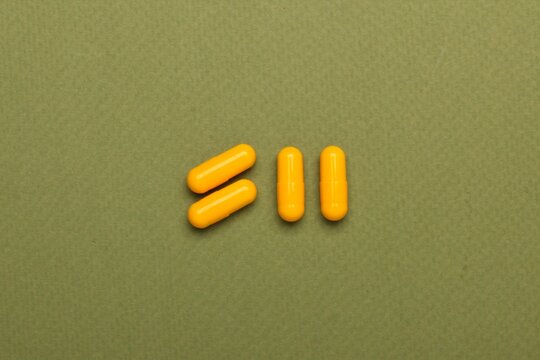 yellow pills on white background