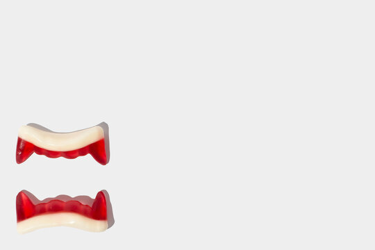 Vampire red teeth candy on a white background. Halloween decoration with copy