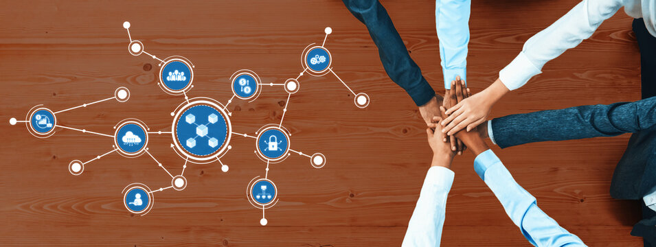 A diverse group of professionals joins hands to symbolize unity and collaboration, emphasizing the importance of teamwork and innovative connectivity in modern business environments. Amity