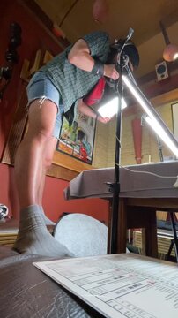 person swinging sword in wooden room with red walls side view dynamic action. commercial adventure scene with wooden furniture and red walls, showcasing dynamic.