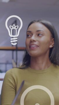 Animation of light bulb icons and data processing over diverse business people