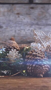 Composition of light over christmas decorations with pine cones
