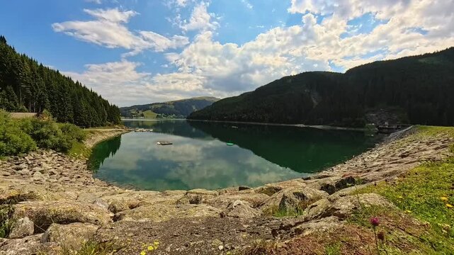 4K Timelapse alpine summer video with moving clouds and reflections at Durlassboden reservoir, Gerlos pass, Oberpinzgau, Zillertal valley, Tyrol, Salzburg, Austria