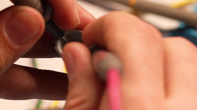 Man hands using multimeter probes to check car electrical connector.