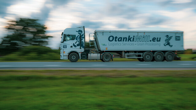 LATVIA - SEPTEMBER 3, 2026: OtankiMill logistics truck transporting grain on a highway with motion blurred countryside background