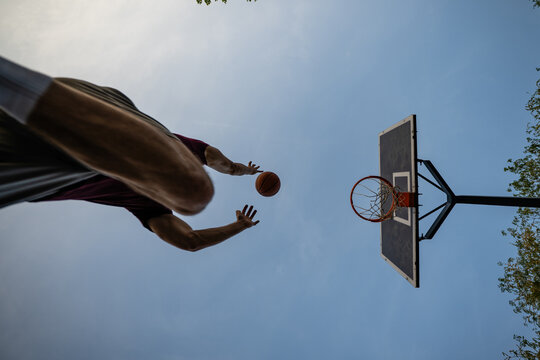 Athlete jumping throwing basketball into hoop