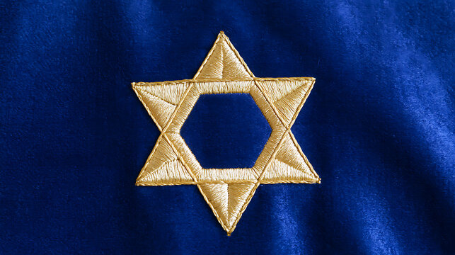 Gold embroidered hexagram star symbol on blue velvet textile background, elegant religious design for background and creative project concepts