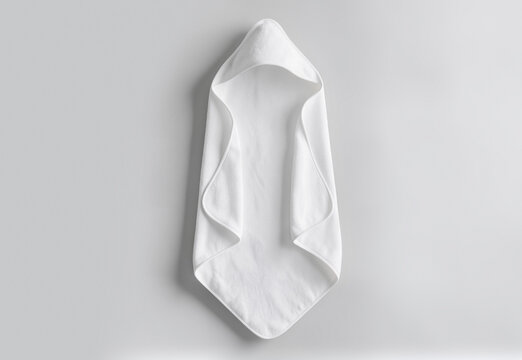 White baby hooded towel flat lay on grey background, ai generated. Cozy hygiene terry with hood for infant care after bath time. Clean soft childcare material for nursery essentials concept.