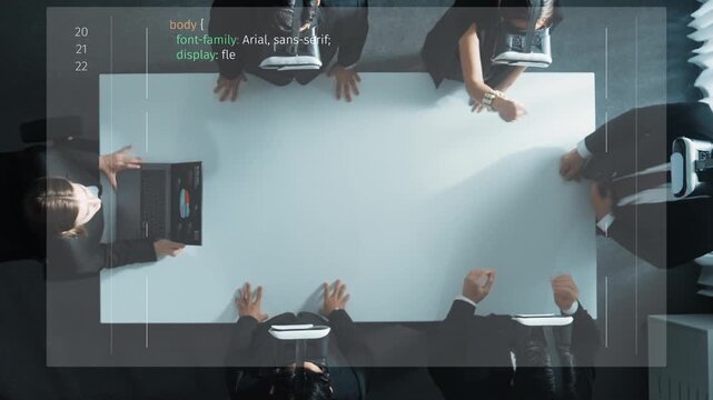 A group of professionals in an office setting collaborates over laptops and a table, showcasing teamwork and project management in software development. Raster