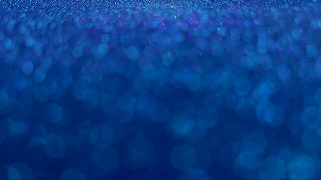 Abstract blue glitter background with soft bokeh effect