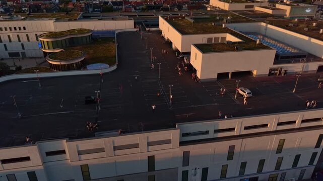 Spectators watch solar eclipse from city parking deck. Best aerial view drone