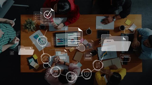 A group of professionals collaborates in a meeting with digital icons overlaying the scene, illustrating data management, workflow, and creative brainstorming processes. Raster