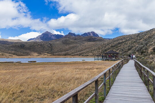 The view from a wooden observation pier and boardwalk trail at the high-altitude Laguna Limpiopungo with the dramatic peaks of the Rumi&ntilde;ahui volcano. Cotopaxi National Park, Ecuador