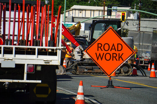 Road work sign with street repairs being done