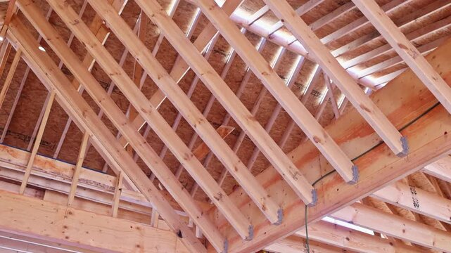 Wooden beams are arranged in roof framing beams structure of building under construction