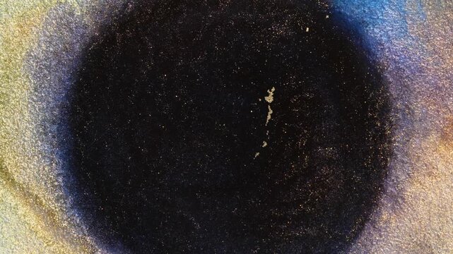 Mixing alcohol ink creates swirls and patterns in macro view