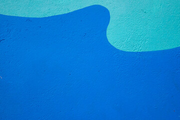 Abstract blue and teal wave pattern on textured wall © ornax photo