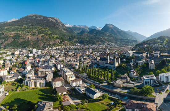 Aerial drone panoramic cityscape view of historic Brig town with Stockalper Palace and the Alps in Valais, Switzerland.
