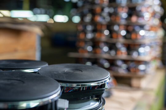 Black industrial speakers with chrome trim in warehouse setting