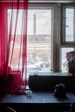 Broken window with glass shards after explosion near thermal power plant during winter attack.