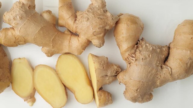 Fresh ginger root and slices isolated on white background