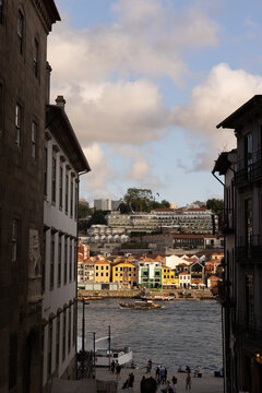 walkway in between historic buildings down to the Douro River in Porto, Portugal in late afternoon