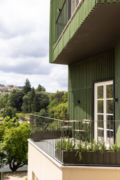 apartment building, green, new construction, near a park with trees in Europe