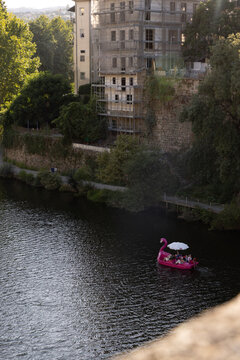 high angle view of swan-shaped boat cruising on the T&acirc;mega River of the town of Amarante, Portugal on a clear day