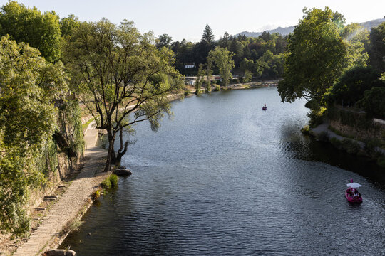 high angle view small boats sailing on the T&acirc;mega River of the town of Amarante, Portugal on a clear day