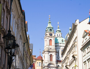 Fototapeta premium View of city street and Church of St. Nicholas in Prague. Czech Republic.