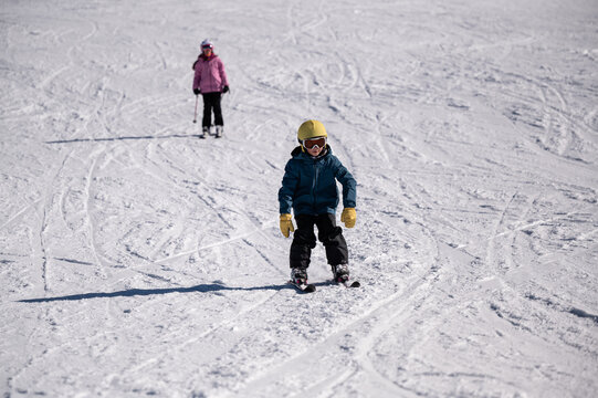 Children skiing on a sunny winter slope