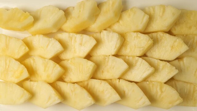 Sliced fresh pineapple pieces isolated on white background