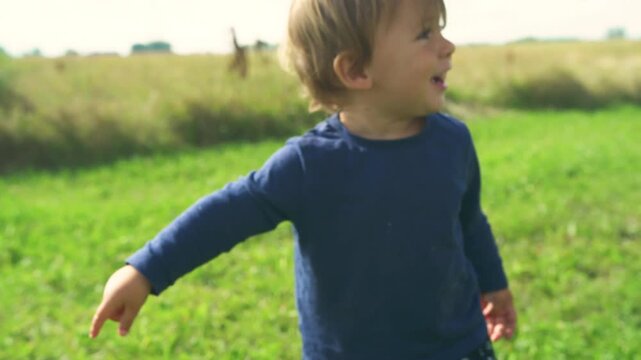 Toddler running across a green field with a low-angle reveal of a wild mushroom in the grass