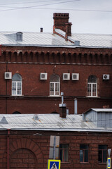 Historic red brick building with modern AC units and roof. High quality photo. © MyJuly