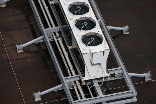 Industrial row of AC units on metal rooftop frame. Top view, technology.