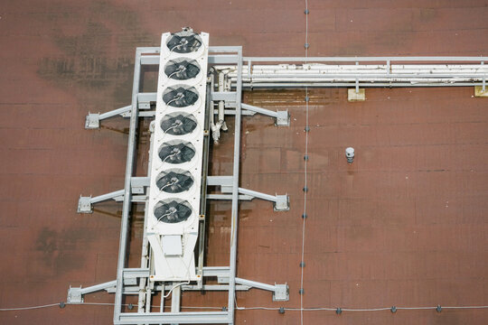 Industrial row of AC units on metal rooftop frame. Top view, technology.
