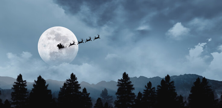 Silhouette of Santa Claus in sleigh with reindeer flying across a full moon over a dark pine forest