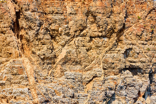 Rugged cliff face bathed in golden sunlight