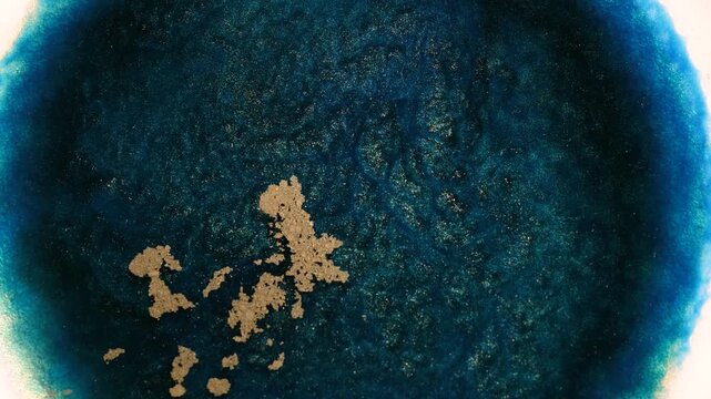 Mixing alcohol ink fragments in a close-up view with different colors