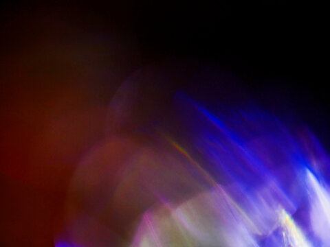 Warm, glowing orb with radiant tendrils. Orange-red hues dominate dark background. Abstract, surreal light effect. Evokes mystery, energy, or cosmic theme. Suitable for sci-fi, fantasy