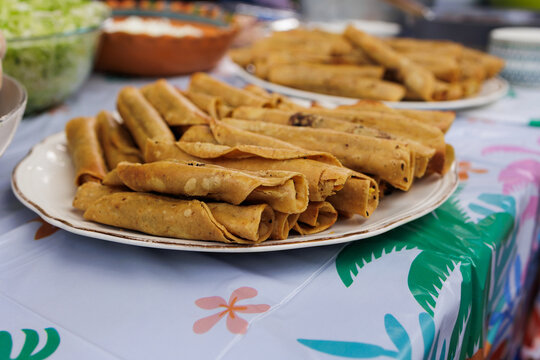 flautas de pollo or chicken fried tacos in Mexico Latin America, Mexican feast with Homemade food on table