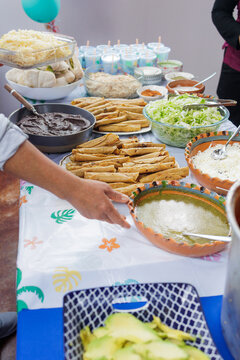 traditional mexican feast and food with flautas de pollo or chicken fried tacos and spicy red sauce in Mexico Latin America, Homemade food on table
