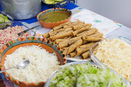 flautas de pollo or chicken fried tacos in Mexico Latin America, Mexican feast with Homemade food on table