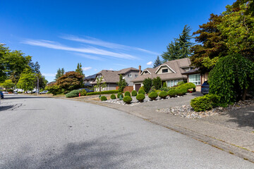 Sunny Suburban Street With Well Kept Houses and Landscaped Front Yards in Fraser Heights Surrey