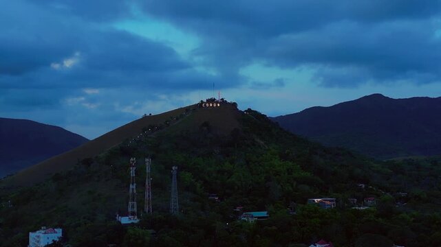Coron town sign illuminating Mount Tapyas at dusk. Great aerial view drone