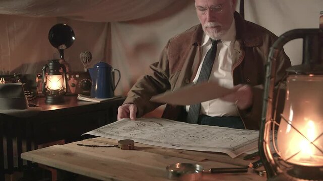 1930s weatherman in a tent looking at a map