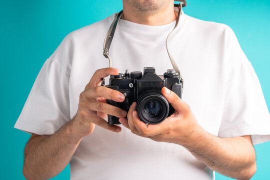 A photographer holds a camera in his hands