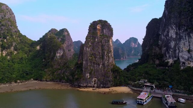 4K Drone View of Bo Hon Island Dock and Towering Limestone Karst Peaks in Ha Long Bay, Vietnam